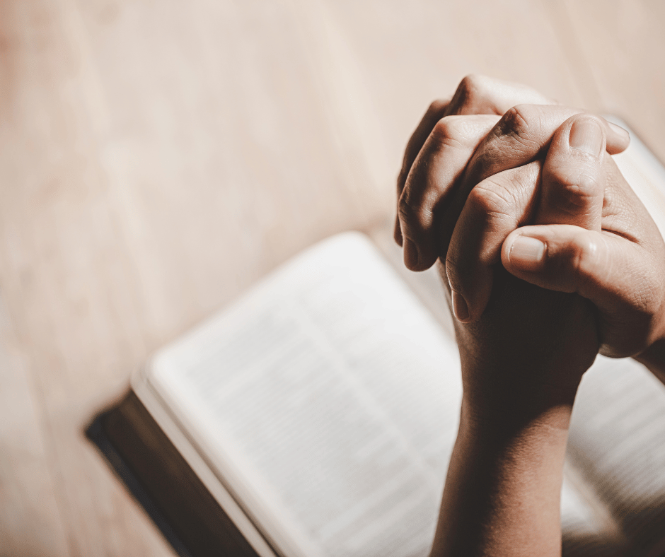 Someone praying with a bible