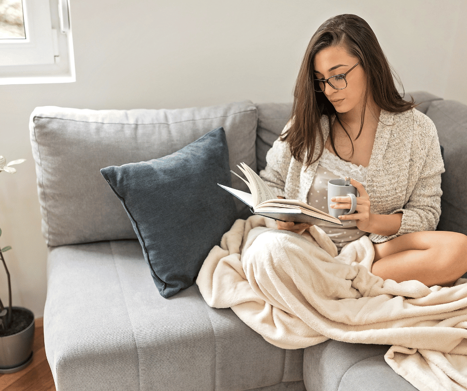 A Lady sitting on a couch reading Christian Parenting Books